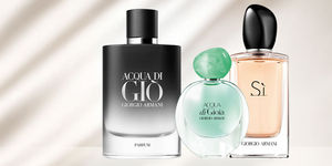 Tre eleganti flaconi di profumo Armani, con design raffinato e colori che variano dal nero al verde acqua al rosa tenue.